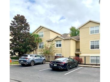 Building exterior with parking lot and landscaping at 413 Summit Ridge Pl # 209, Longwood, FL 32779