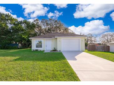 Newly constructed light yellow house with a two-car garage at 514 Margaret Ln, Lake Wales, FL 33853