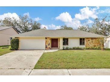 Ranch home with stone facade and attached garage at 2709 Canterclub Trl, Apopka, FL 32712