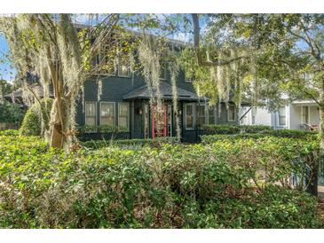 Charming two-story home with mature landscaping and red front door at 706 E Pine St # 5, Orlando, FL 32801
