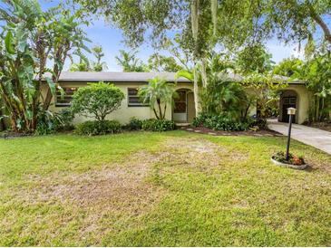 Landscaped front yard with lush tropical plants at 180 N Lakewood Cir, Maitland, FL 32751