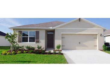 One-story home with landscaped yard and two-car garage at 4161 Singing Mockingbird Blvd, Bartow, FL 33830