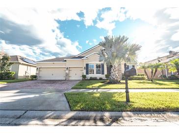 Two-story home with a three-car garage and a landscaped yard at 1511 Alligator St, St Cloud, FL 34771