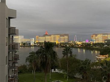 Stunning aerial view of the condo, showcasing the resort-style amenities and beautiful lake at 6165 Carrier Dr # 2602, Orlando, FL 32819