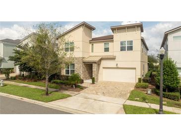 Two-story house with stone accents and a two-car garage at 9043 Sunshine Ridge Loop, Kissimmee, FL 34747