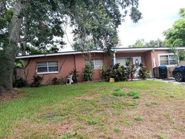 Front view of ranch house with landscaping and driveway at 222 Ronnie Cir, Orlando, FL 32811