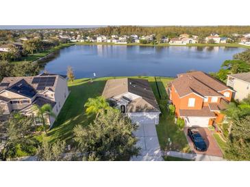 Stunning aerial view of two homes near a lake at 15017 Braywood Trl, Orlando, FL 32824