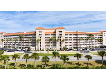 Multi-story building with orange roof and palm trees at 5501 S Atlantic Ave # 307, New Smyrna Beach, FL 32169