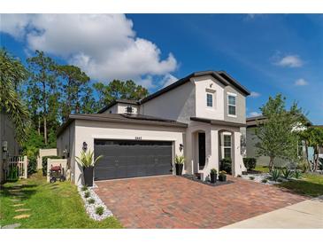 Two-story home with a dark gray garage door at 5443 Carrara Ct, St Cloud, FL 34771