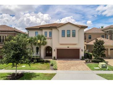 Two-story home with a brown door and three-car garage at 1110 Watson Ct, Reunion, FL 34747