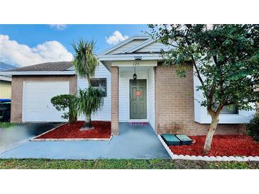 Charming one-story house with a brick facade and well-manicured lawn at 125 Grand Junction Blvd, Orlando, FL 32835