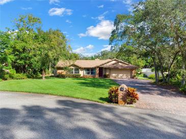 Single-story house with attached garage and well-manicured lawn at 2711 Ambrosia Ct, Apopka, FL 32703