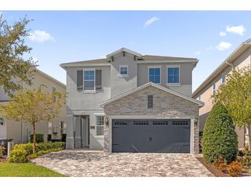 Beautiful two-story home with stone accents and a large driveway at 365 Southfield St, Kissimmee, FL 34747