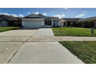 House exterior showing a one-story home with a two-car garage and well-maintained lawn at 4612 Cheyenne Point Trl, Kissimmee, FL 34746