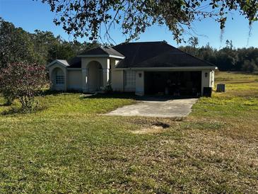 One-story house with attached garage and large yard at 12520 Dry Fork Rd, Groveland, FL 34736