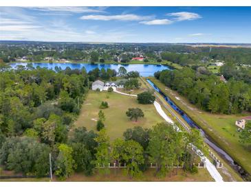 Aerial view of house on a large lot, near lake and canal at 20733 Oberly Pkwy, Orlando, FL 32833