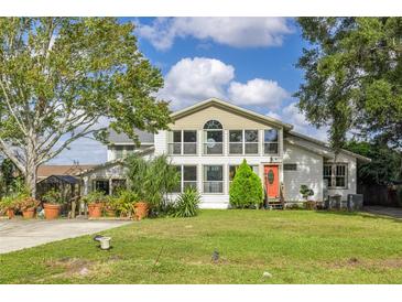 Two-story home with a large front yard and landscaping at 4801 Beach Blvd, Orlando, FL 32803
