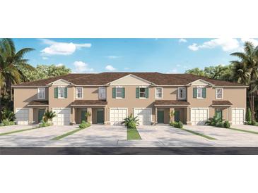 Modern townhouses with attached garages and green landscaping at 692 Preston Cove Dr, St Cloud, FL 34771
