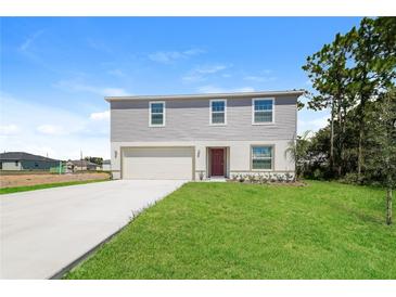 Two-story house with attached garage and landscaped lawn at 1432 Punta Gorda Dr, Kissimmee, FL 34759