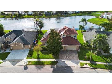 Two-story home with lake view and solar panels at 2626 Raccoon Run Ln, Orlando, FL 32837