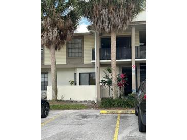 Condo building with palm trees and parking lot in front at 6008 Village Cir # Ge, Orlando, FL 32822