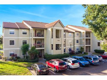Two-story condo building with ample parking and landscaping at 3012 Parkway Blvd # 102, Kissimmee, FL 34747