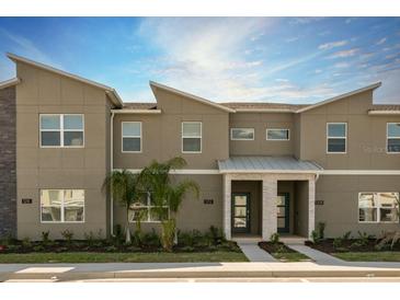 Modern two-story townhome with attached garage and landscaping at 1212 Challenge Dr, Davenport, FL 33896