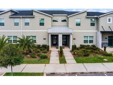 Modern townhome with 2 units and a paved walkway at 4285 Quote St, Kissimmee, FL 34746
