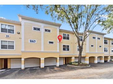 Tan building with multiple units, garages, and landscaping at 1825 Shadow View Cir # 1825, Maitland, FL 32751