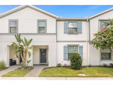 Two-story townhome with gray siding and blue shutters at 2412 Dubai St, Kissimmee, FL 34747