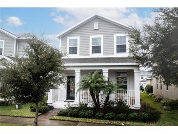 Two-story craftsman home with gray siding and front porch at 12152 Illustration Dr, Orlando, FL 32832