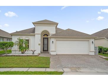 One-story house with a two-car garage, landscaping, and a paved driveway at 4001 Scarlet Branch Rd, Orlando, FL 32824