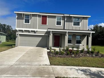 Two-story house with gray siding and red accents at 4255 Green Gables Pl, Kissimmee, FL 34746