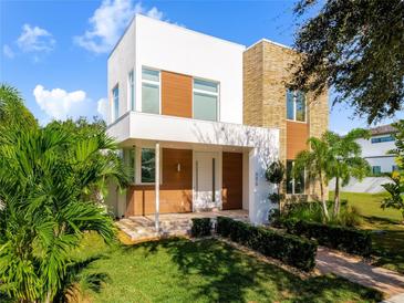 Modern two-story home with light-colored siding and stone accents at 8619 Farthington Way, Orlando, FL 32827