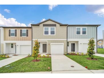 Modern townhome with two-car garage and landscaping at 246 Mandovi St, Davenport, FL 33837