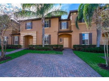 Townhouse exterior with brick driveway and landscaping at 3520 Calabria Ave # 3520, Davenport, FL 33897