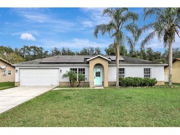 House exterior featuring a garage and landscaping at 1053 E Hancock Dr, Deltona, FL 32725