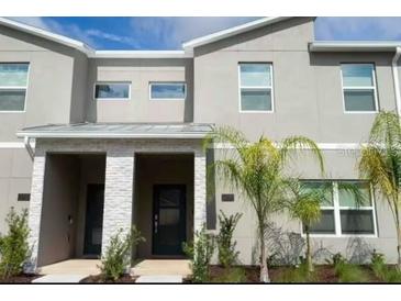Modern two-story townhome with palm trees at 1144 Challenge Dr, Davenport, FL 33896