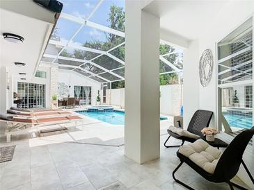 Relaxing screened-in pool area with lounge chairs and seating at 3211 Sunrise Walk, Kissimmee, FL 34747