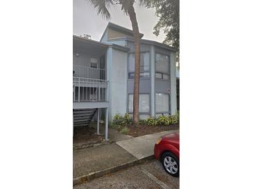 Condo building exterior with a palm tree and parking at 2546 Lemon Tree Ln # 4, Orlando, FL 32839