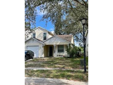 Two-story house with attached garage and front porch at 6776 Brittany Chase Ct, Orlando, FL 32810