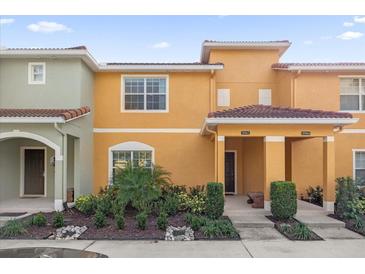 Two-story townhome with landscaping and front porch at 8962 Cuban Palm Rd, Kissimmee, FL 34747