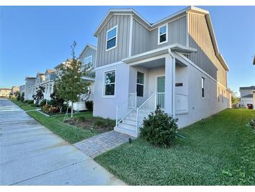 Two-story home with gray siding and white accents at 1652 Cross Prairie Pkwy, Kissimmee, FL 34744