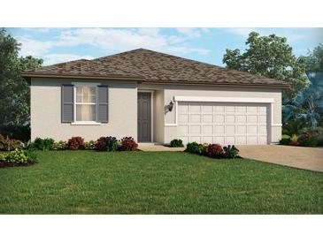 One-story home with a two-car garage, landscaping, and gray shutters at 375 Birkdale Dr, Daytona Beach, FL 32124