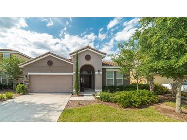 One-story home with attached garage and well-manicured landscaping at 5160 Oakbourne Ave, Davenport, FL 33837