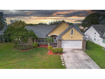 Attractive one-story home with a landscaped yard and two-car garage at 12512 Tillingham Sw Ct, Orlando, FL 32837