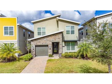 Modern two-story home with stone accents and a two-car garage at 2770 Bookmark Dr, Kissimmee, FL 34746