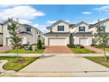 Two story townhome with two car garage and brick paver driveway at 1174 Seaside Mist Trl, Kissimmee, FL 34747