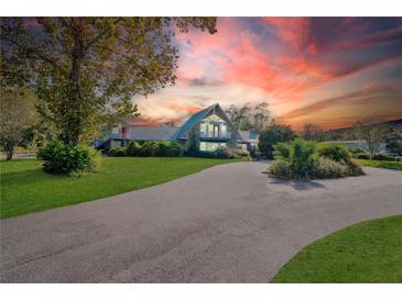 A-frame house exterior at sunset, long driveway at 4150 Citrus St, Kissimmee, FL 34746