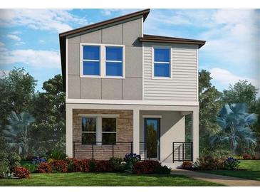 Two-story modern home with stone accents and landscaped front yard at 5009 Railroad Vine Aly, Winter Garden, FL 34787